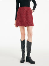 A lady wears a red mini skirt.